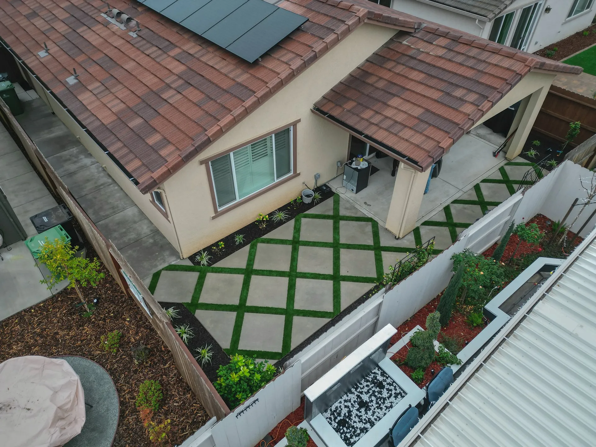 Aerial view of a diamond paver and turf patio in a Sacramento backyard