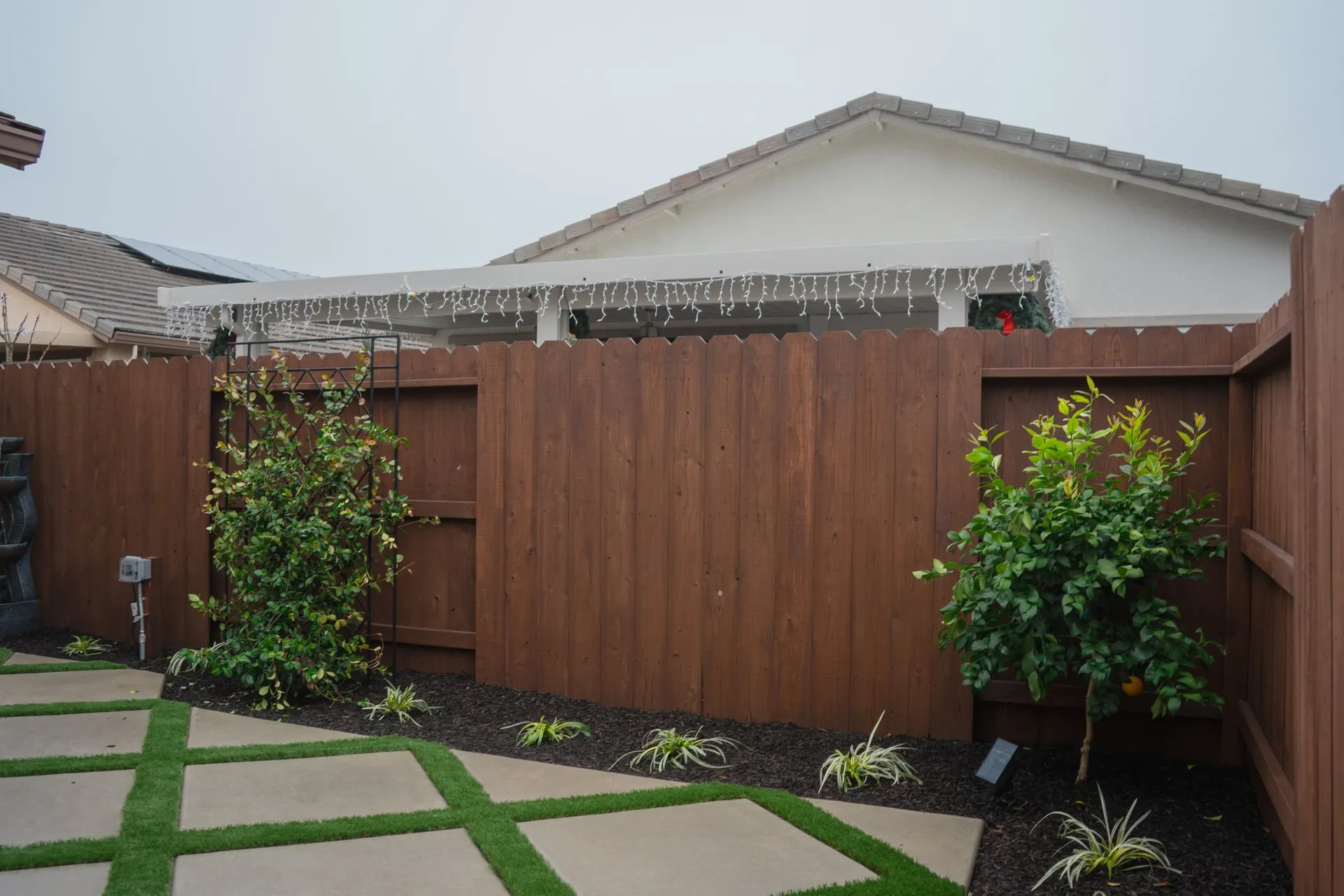 Paver walkway with turf panel and mulch planting beds at a Sacramento home
