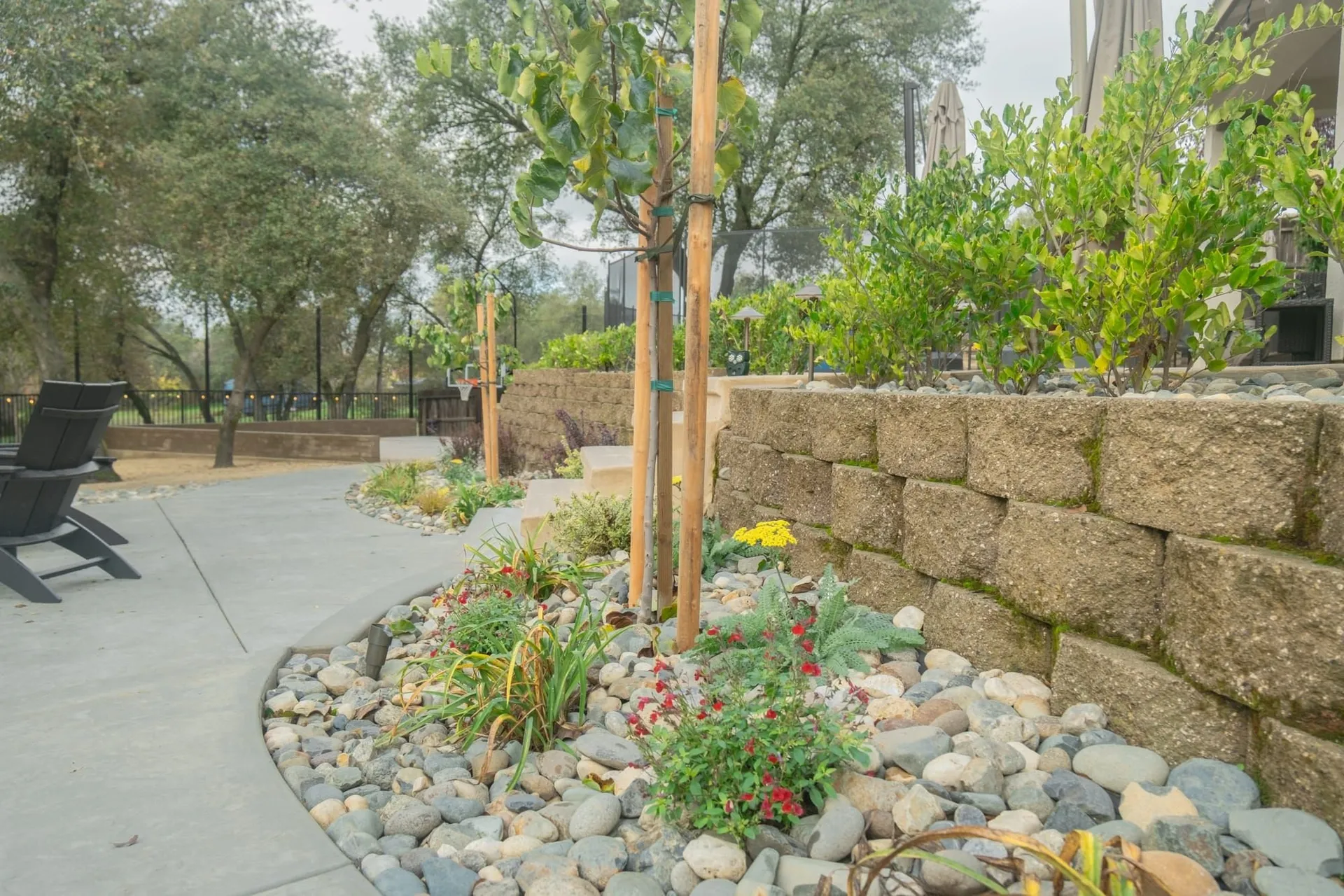 Block retaining wall with cap stones holding a raised planting bed at a Sacramento home