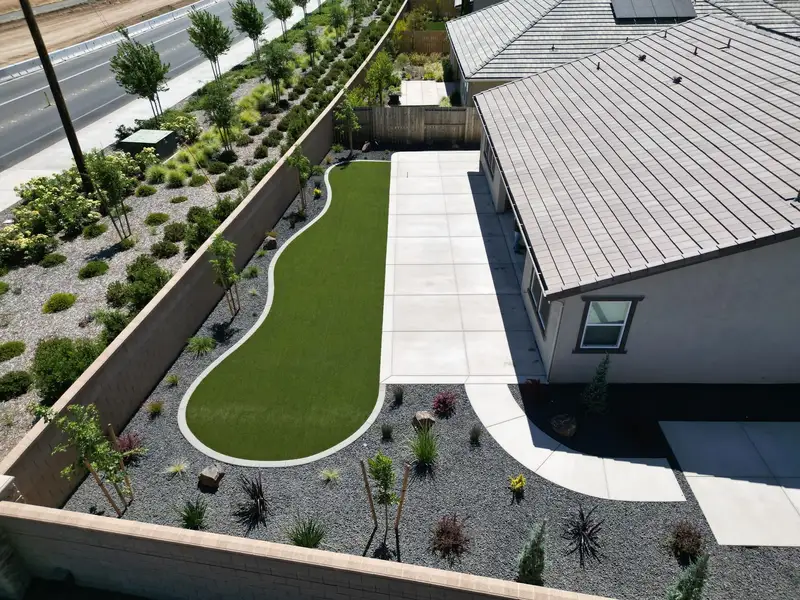 Complete Sacramento landscape renovation with turf, concrete patio, and drought-tolerant plantings