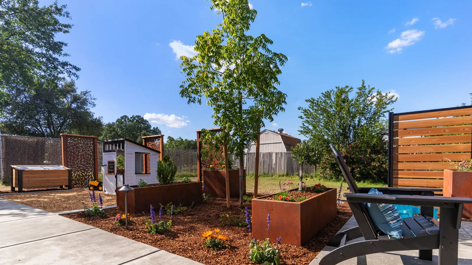Corten steel planters and new trees along the patio edge